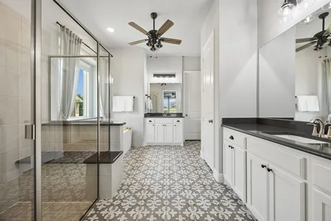 a bathroom with a sink a mirror and a shower