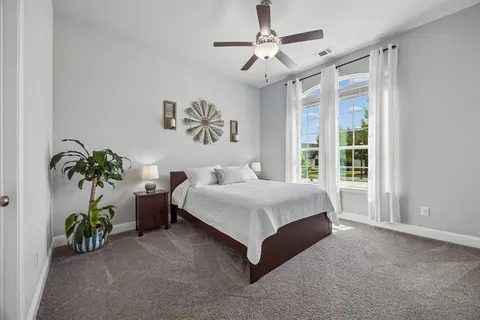 a spacious bedroom with a bed and a window