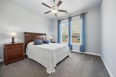 a bedroom with a large bed and a window