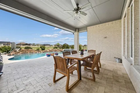 a view of a patio with a table and chairs
