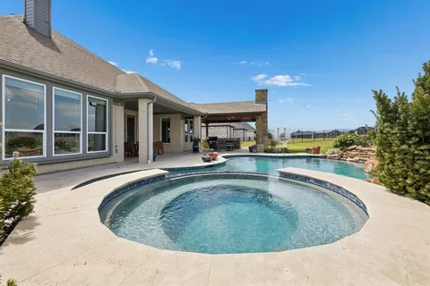 a view of a swimming pool with outdoor seating