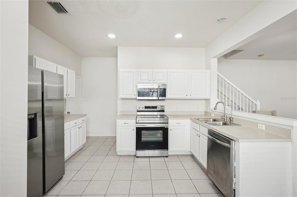 5001 Barnstead Drive Riverview, FL 33578 - Photo 12 of 37 a kitchen with a stove sink and refrigerator