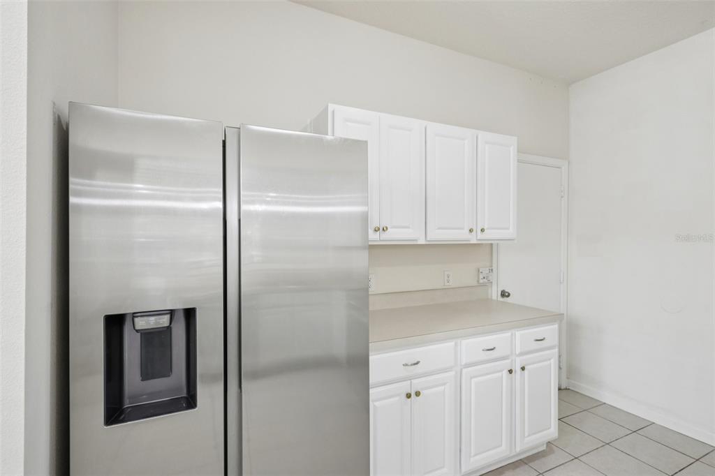 5001 Barnstead Drive Riverview, FL 33578 - Photo 13 of 37 a kitchen with cabinets and a refrigerator