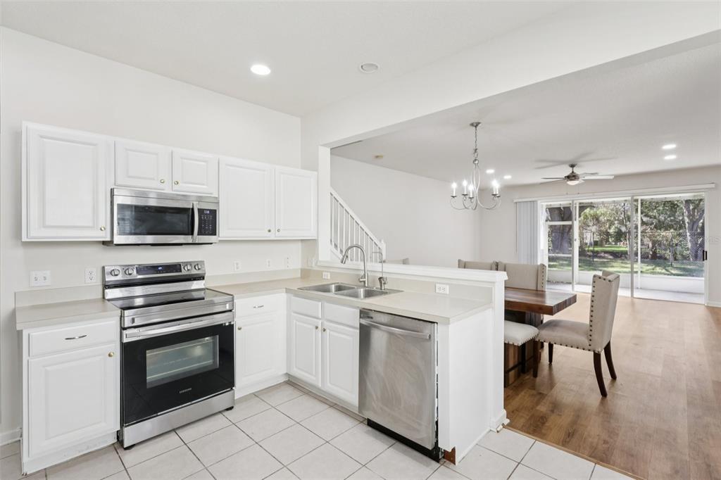 5001 Barnstead Drive Riverview, FL 33578 - Photo 14 of 37 a kitchen with white cabinets and white appliances