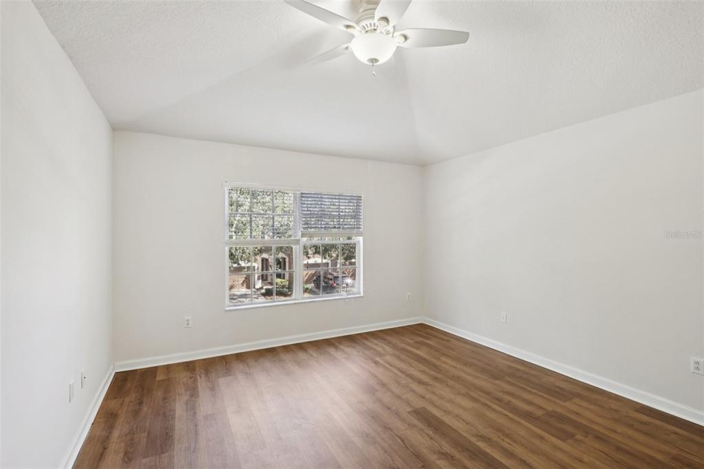 5001 Barnstead Drive Riverview, FL 33578 - Photo 18 of 37 an empty room with wooden floor fan and windows