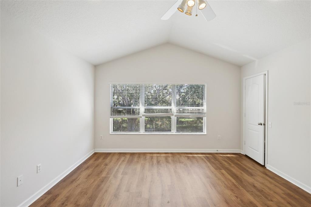 5001 Barnstead Drive Riverview, FL 33578 - Photo 22 of 37 an empty room with wooden floor and windows
