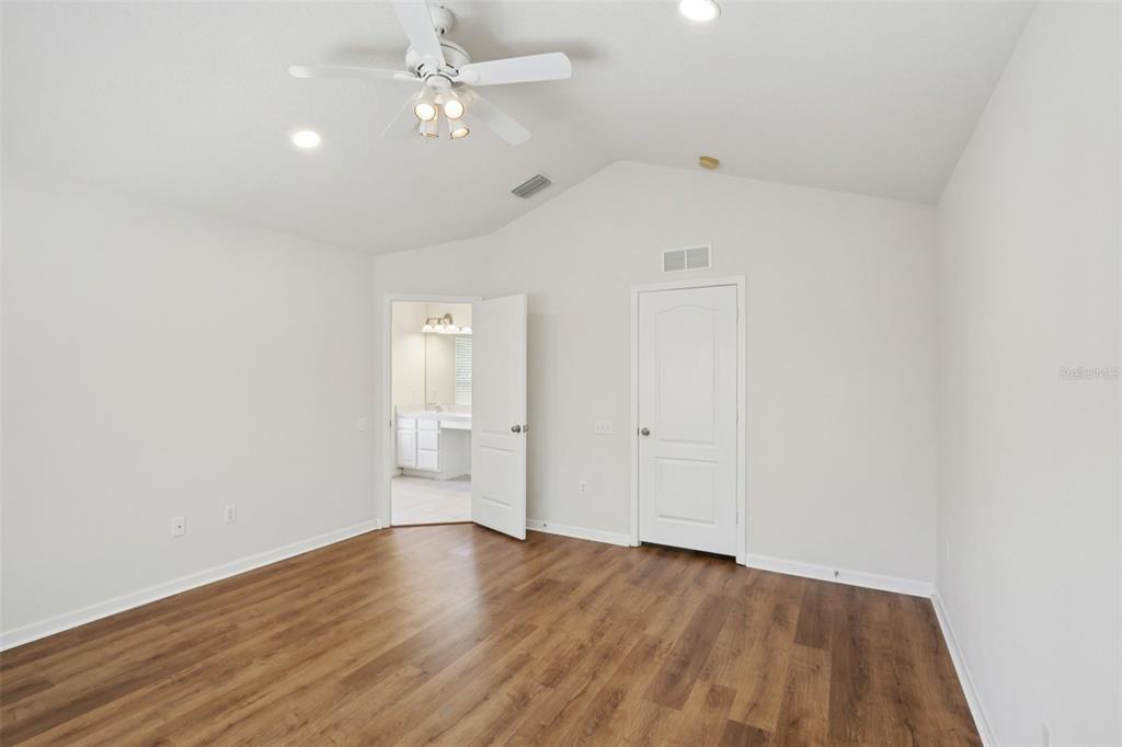 5001 Barnstead Drive Riverview, FL 33578 - Photo 23 of 37 an empty room with wooden floor and windows
