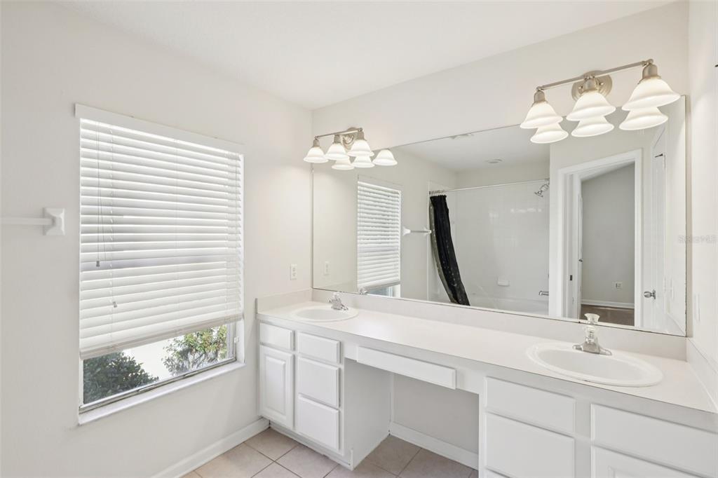 5001 Barnstead Drive Riverview, FL 33578 - Photo 25 of 37 a bathroom with a double vanity sink and a mirror