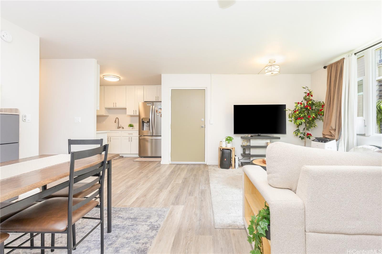 98-1032 Moanalua Road, Unit 3103 Aiea, HI 96701 - Photo 2 of 10 a living room with furniture and a flat screen tv