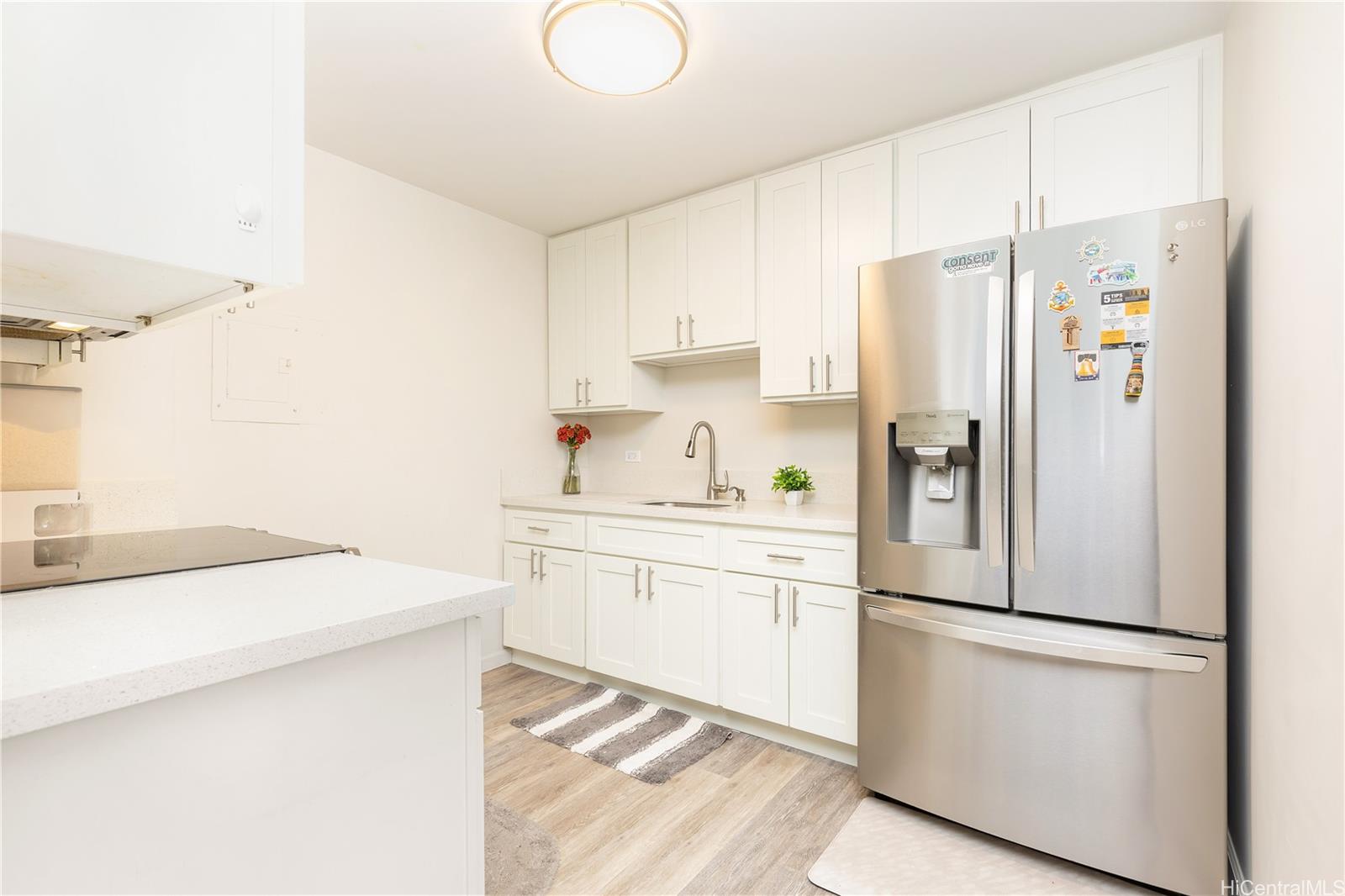 98-1032 Moanalua Road, Unit 3103 Aiea, HI 96701 - Photo 3 of 10 a white refrigerator freezer sitting in a kitchen