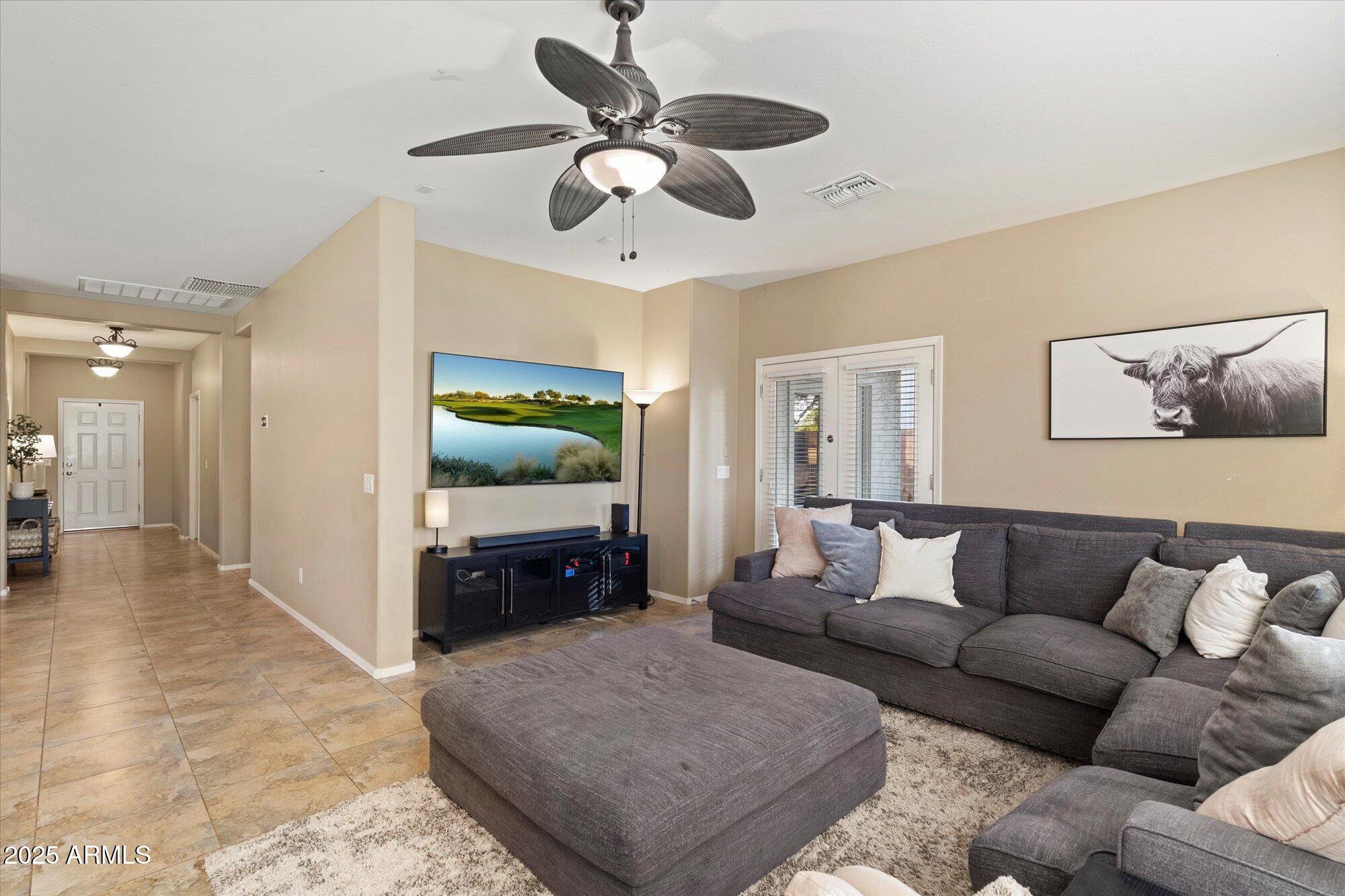 6710 South Seton Avenue Gilbert, AZ 85298 - Photo 20 of 51 a living room with furniture and a chandelier