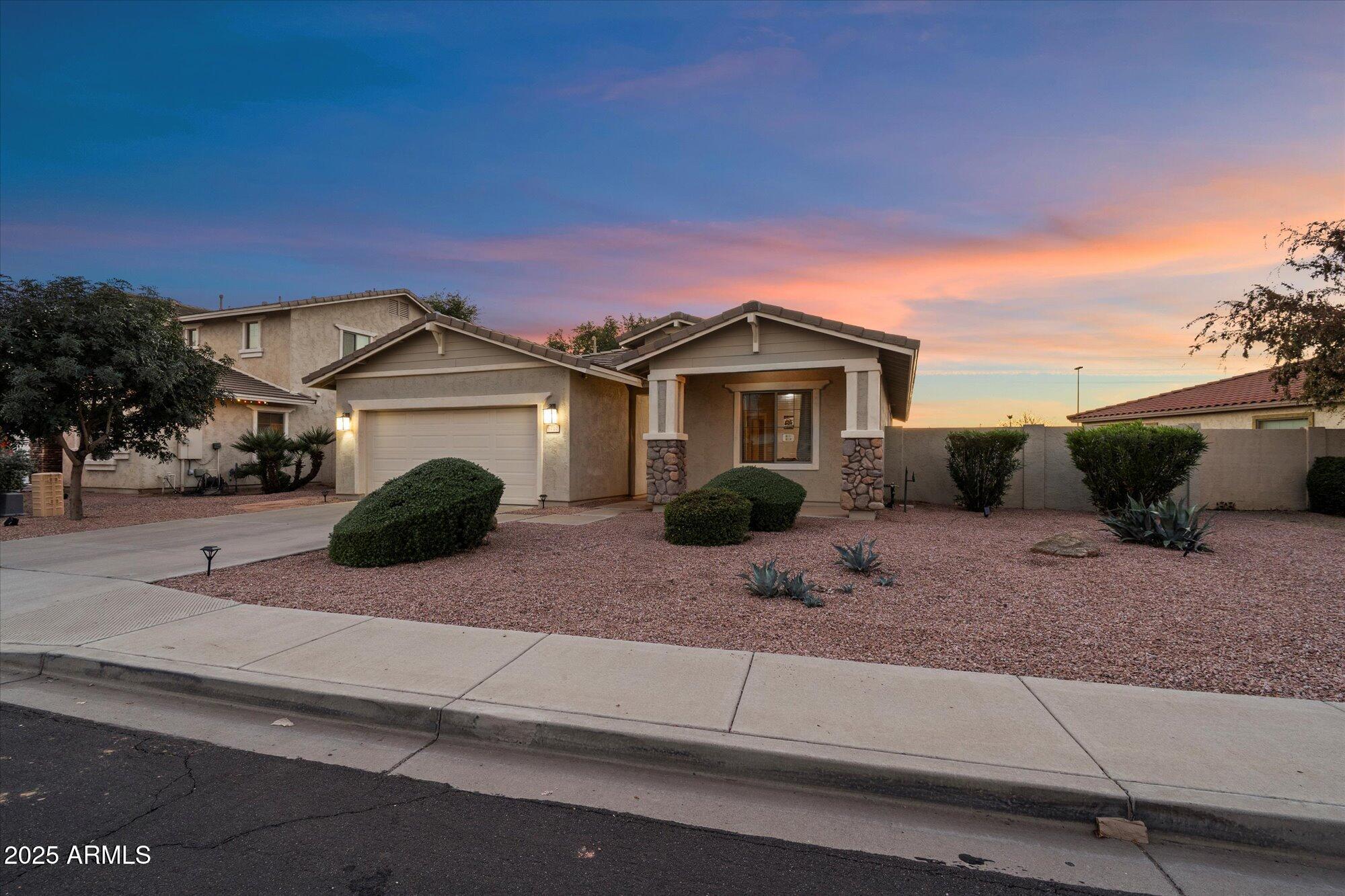 6710 South Seton Avenue Gilbert, AZ 85298 - Photo 2 of 51 a front view of a house with a yard
