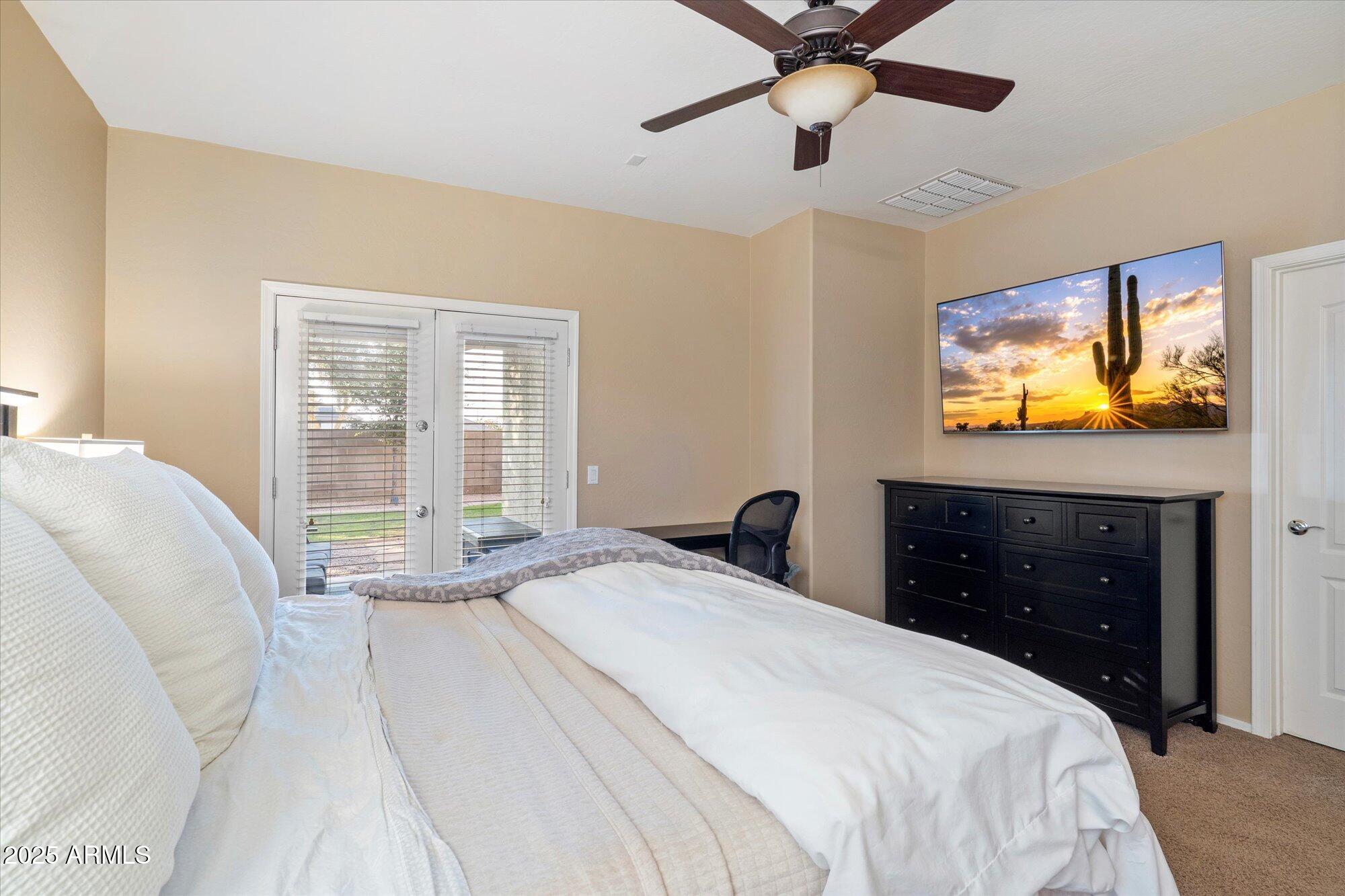 6710 South Seton Avenue Gilbert, AZ 85298 - Photo 21 of 51 a bedroom with a bed and a flat screen tv