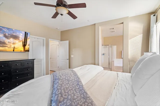 a bedroom with a bed and a flat screen tv