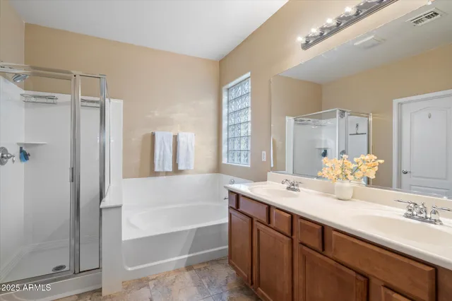 a bathroom with a tub sink and mirror