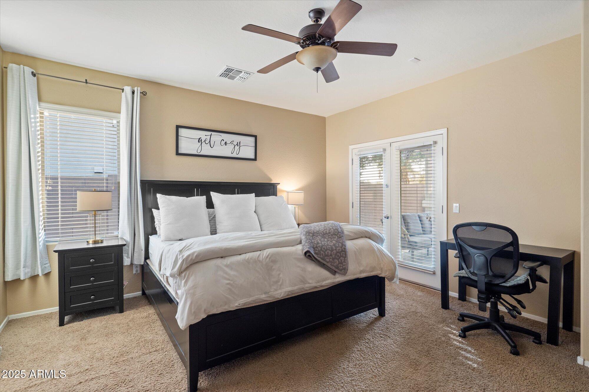 6710 South Seton Avenue Gilbert, AZ 85298 - Photo 24 of 51 a bedroom with a bed and a chandelier