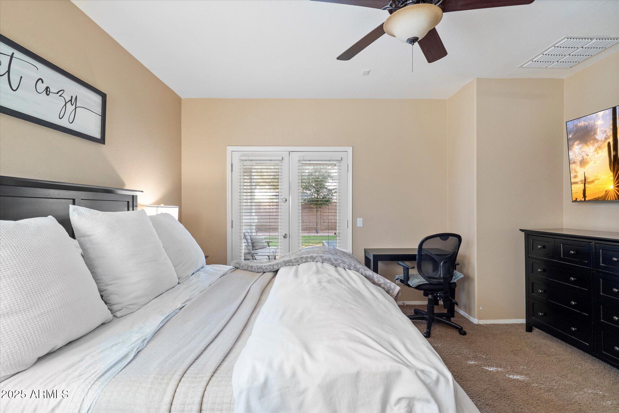 6710 South Seton Avenue Gilbert, AZ 85298 - Photo 25 of 51 a bedroom with a bed and a tv