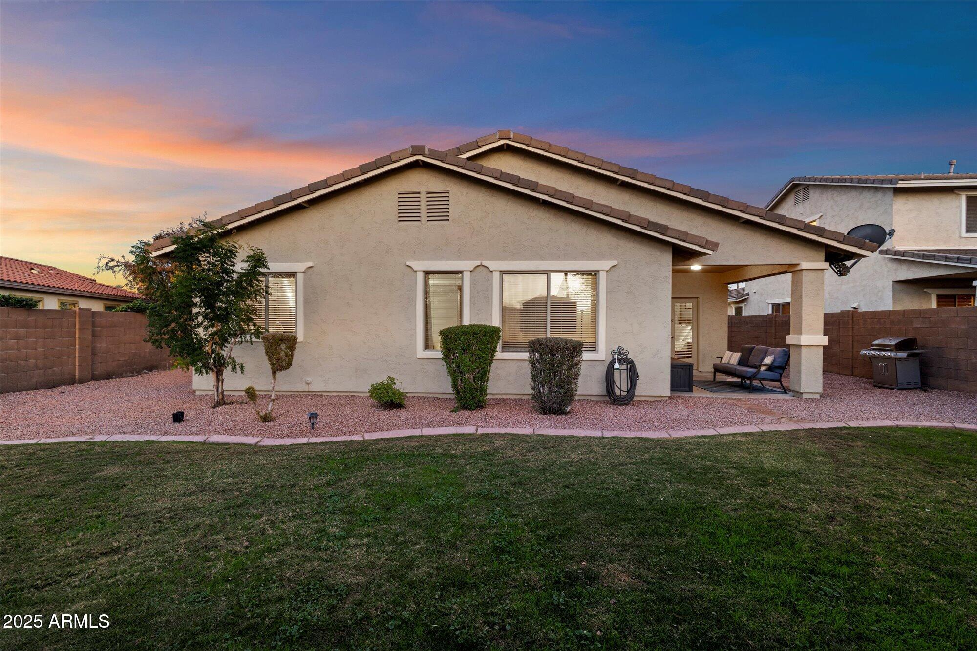 6710 South Seton Avenue Gilbert, AZ 85298 - Photo 36 of 51 a view of a house with a patio and a yard