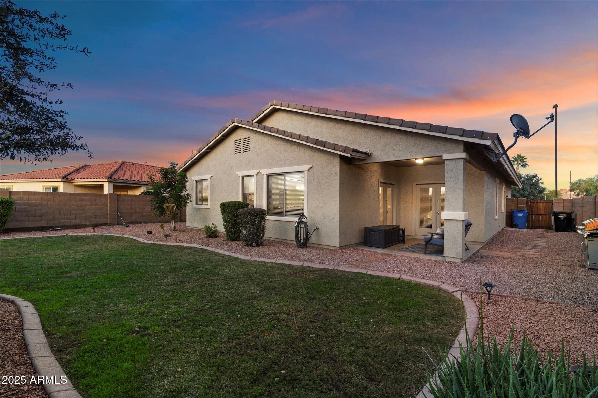 6710 South Seton Avenue Gilbert, AZ 85298 - Photo 38 of 51 a front view of a house with a yard fire pit and outdoor seating