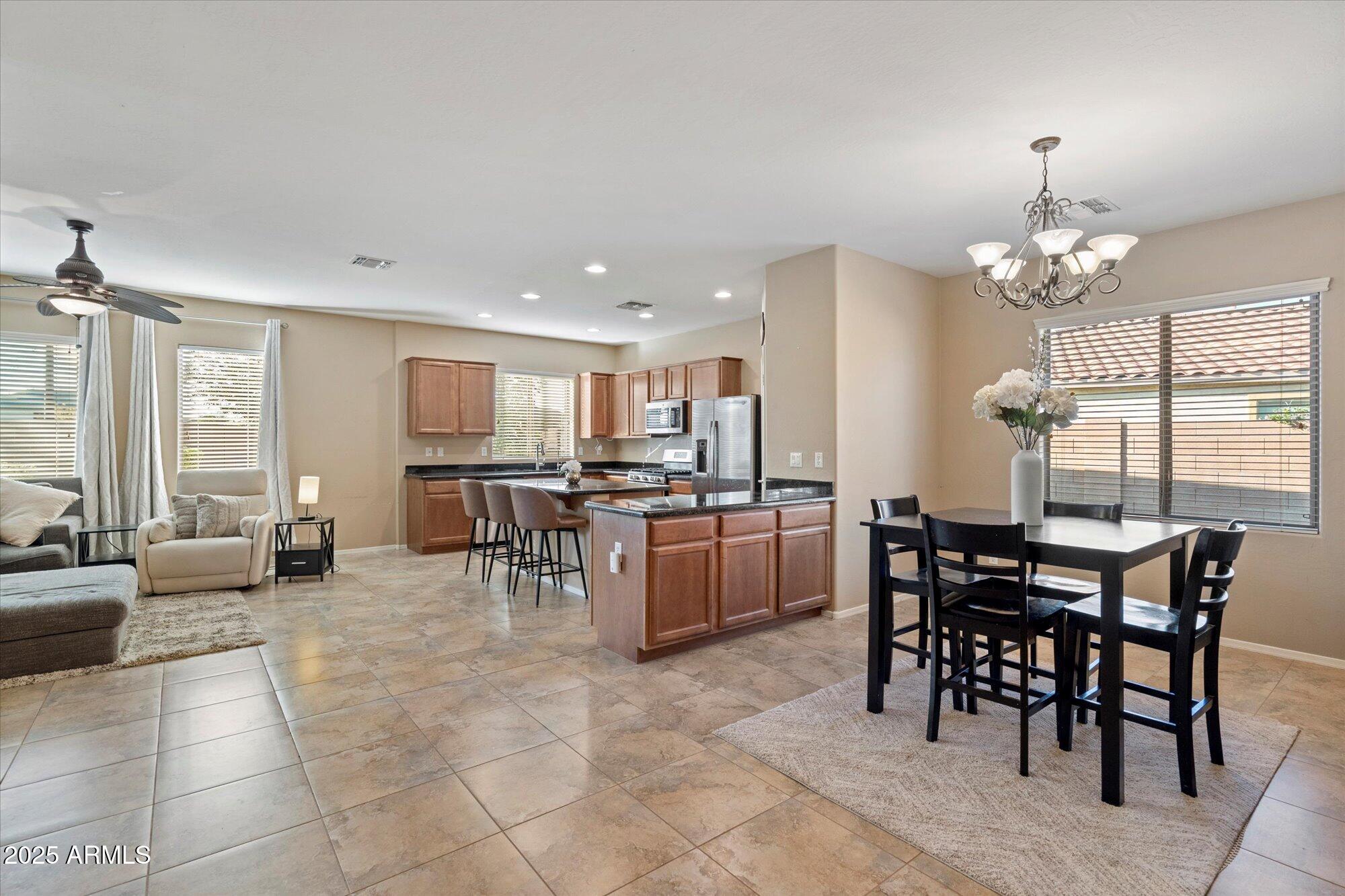 6710 South Seton Avenue Gilbert, AZ 85298 - Photo 7 of 51 a view of a dining room with furniture and chandelier