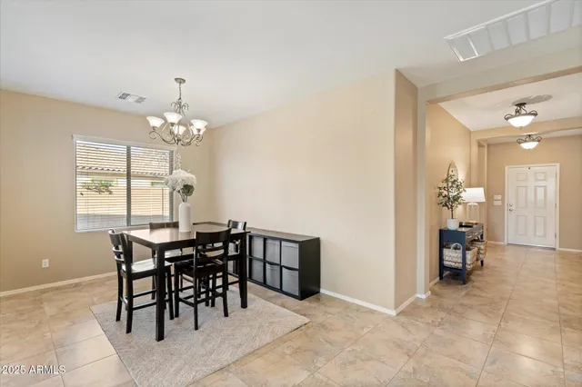 a view of a dining room with furniture and chandelier