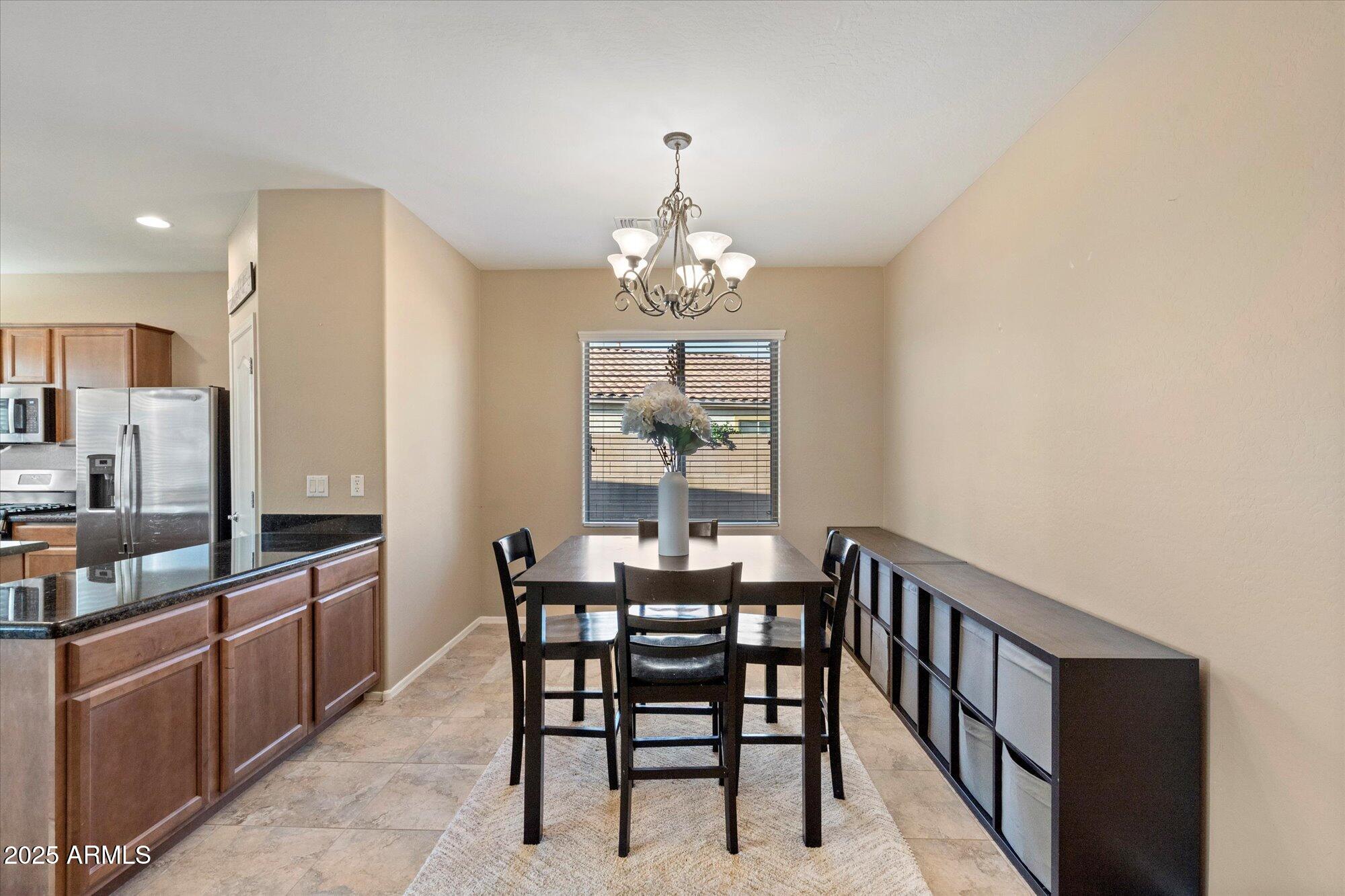 6710 South Seton Avenue Gilbert, AZ 85298 - Photo 9 of 51 a view of a dining room with furniture and window