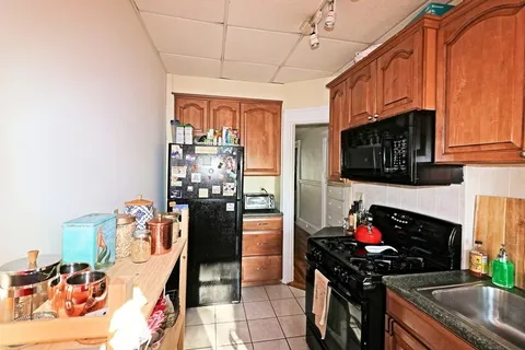 a kitchen with stainless steel appliances granite countertop a stove and a refrigerator