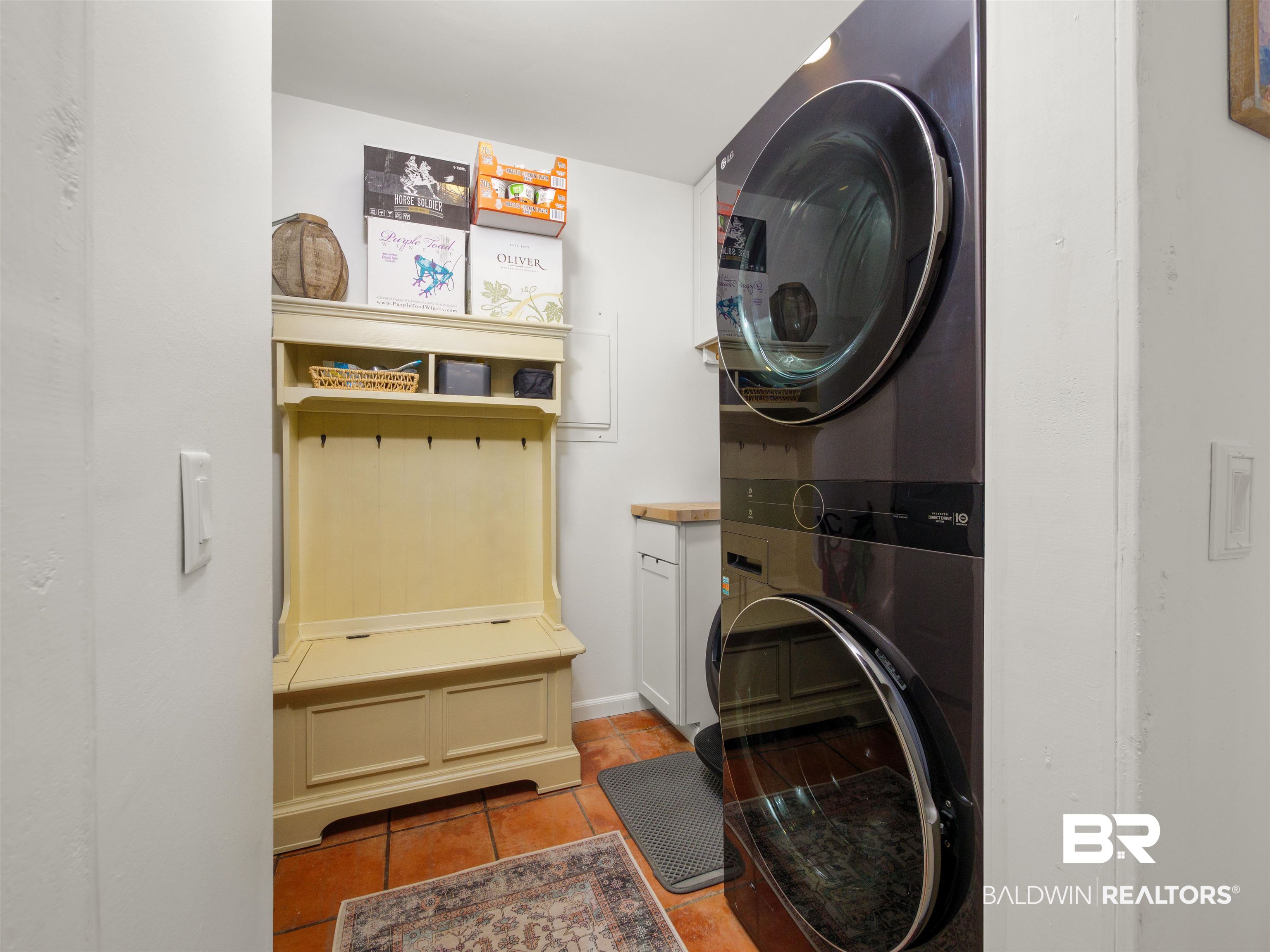 494 Ridgewood Drive Daphne, AL 36526 - Photo 12 of 40 Clothes washing area featuring stacked washer / drying machine and light tile patterned flooring
