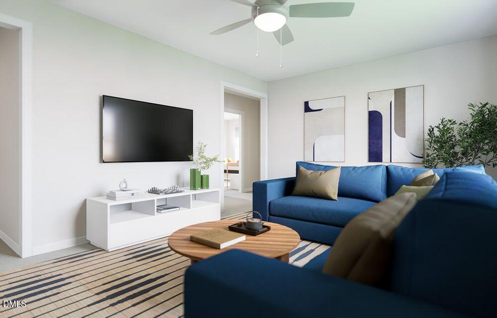 740 Bolera Road Knightdale, NC 27545 - Photo 12 of 32 a living room with furniture and a flat screen tv