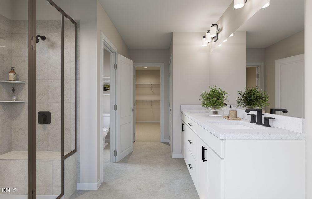 740 Bolera Road Knightdale, NC 27545 - Photo 14 of 32 a bathroom with a double vanity sink and mirror