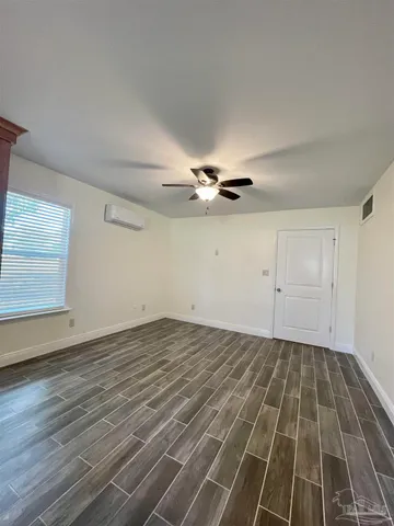 a view of a room with wooden floor closet and windows