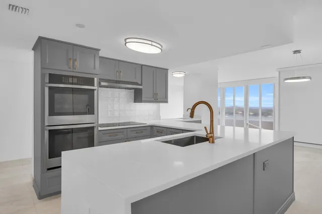 a kitchen with a refrigerator and a sink