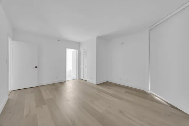 a view of an empty room and wooden floor