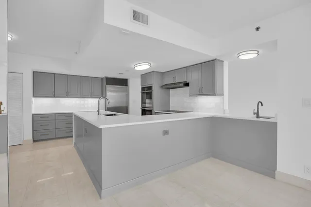 a kitchen with cabinets and white appliances