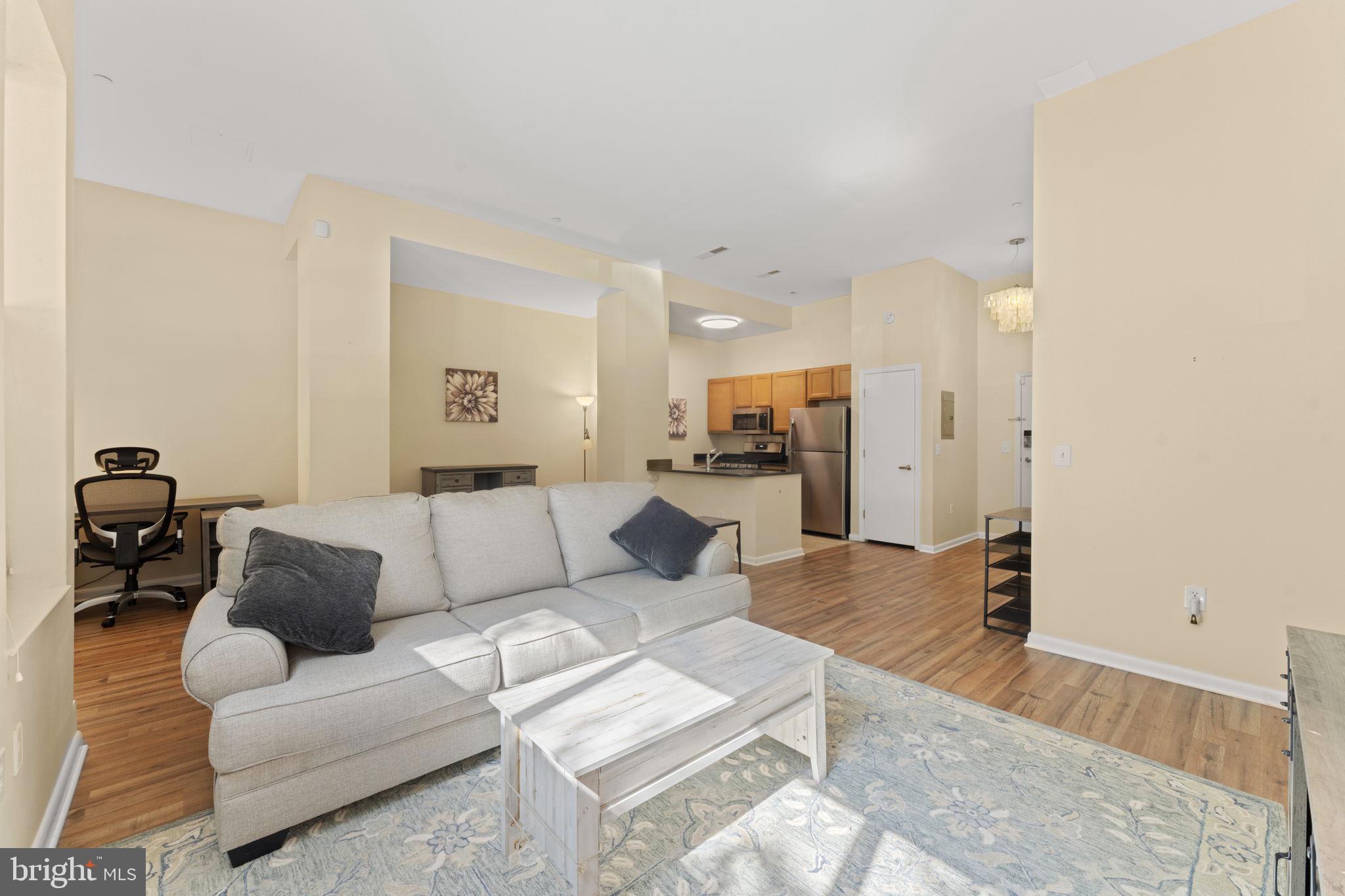 355 I Street Southwest, Unit S104 Washington, DC 20024 - Photo 11 of 64 a living room with furniture and a wooden floor