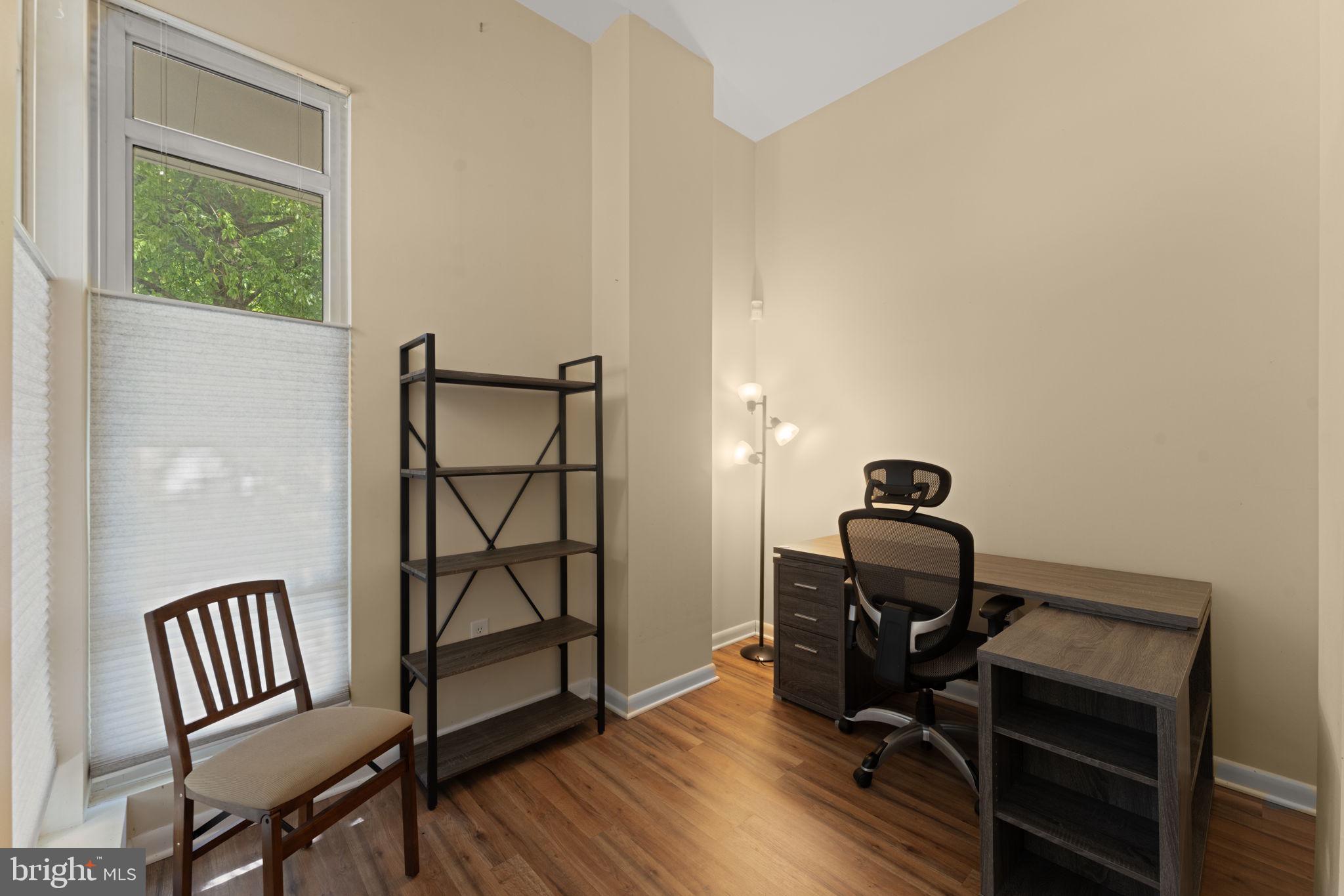 355 I Street Southwest, Unit S104 Washington, DC 20024 - Photo 13 of 64 a view of a workspace with furniture and wooden floor