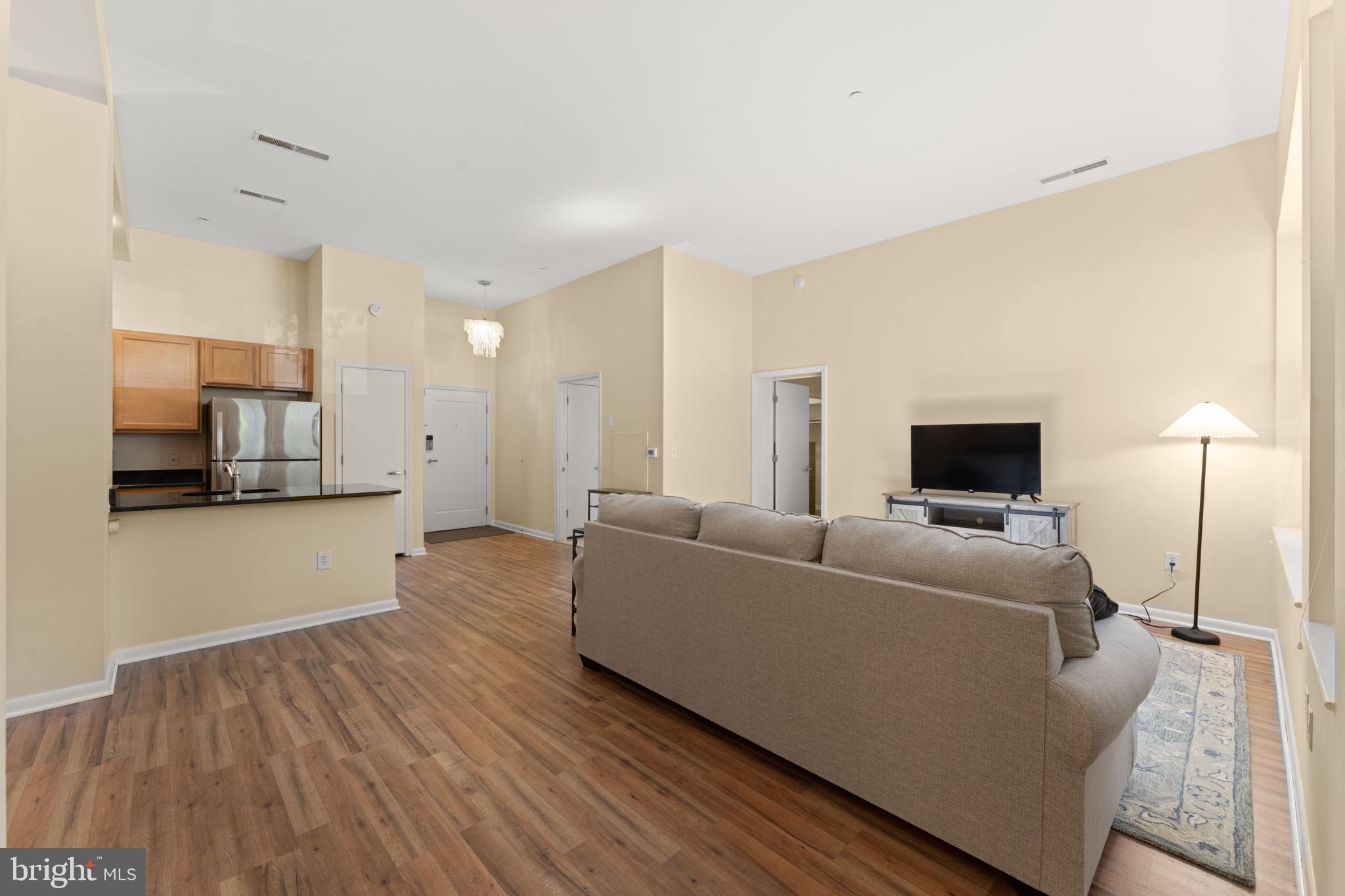 355 I Street Southwest, Unit S104 Washington, DC 20024 - Photo 14 of 64 a living room with furniture and a flat screen tv
