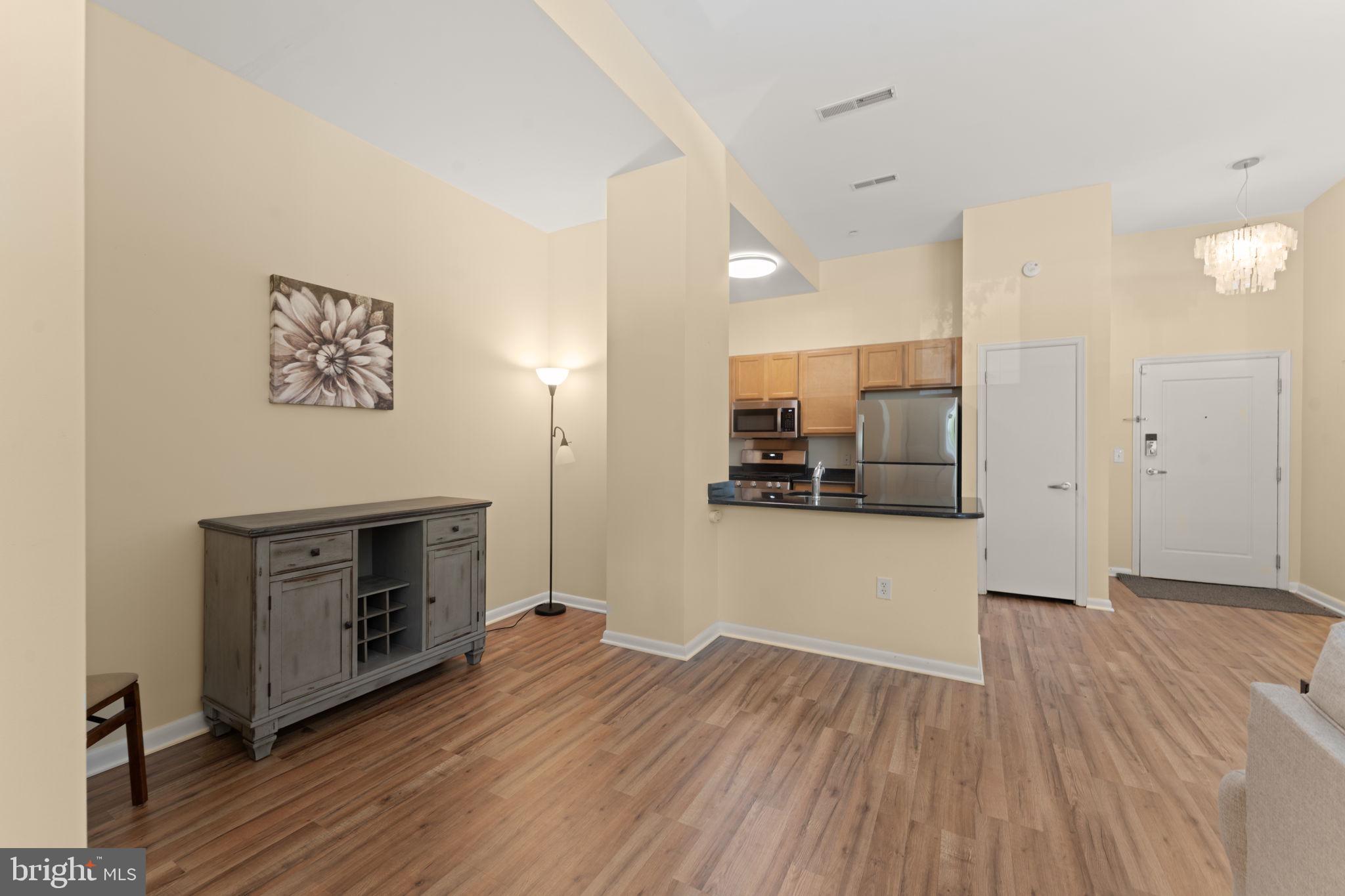 355 I Street Southwest, Unit S104 Washington, DC 20024 - Photo 15 of 64 a view of kitchen and hallway with wooden floor