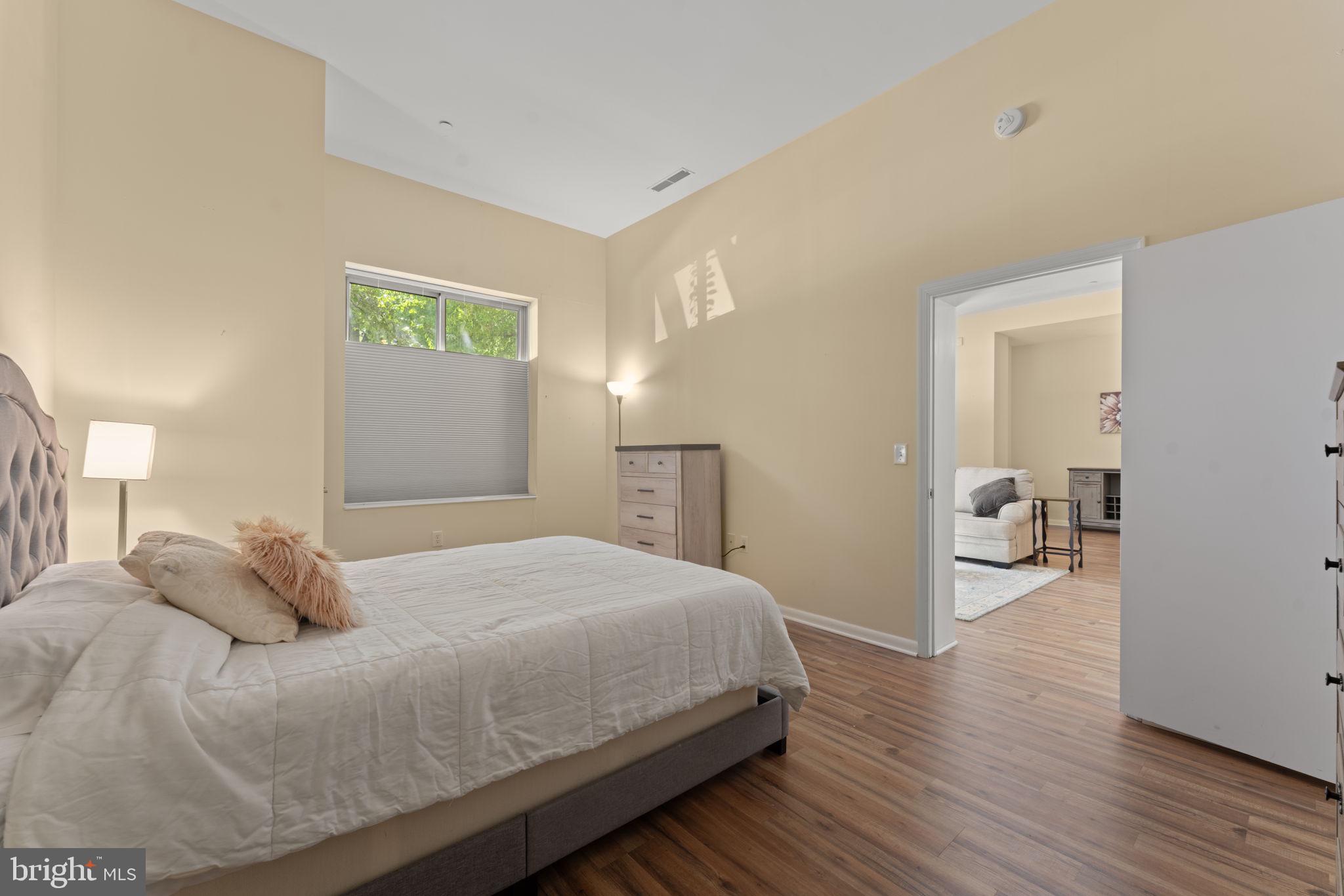 355 I Street Southwest, Unit S104 Washington, DC 20024 - Photo 17 of 64 a bedroom with a bed and a chandelier