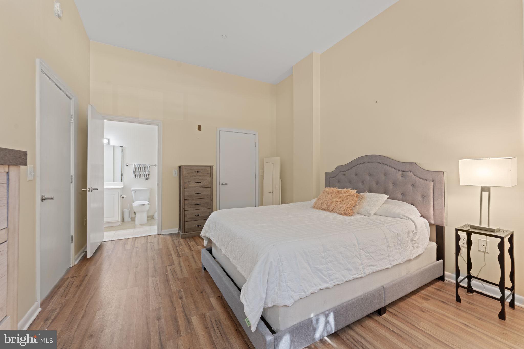 355 I Street Southwest, Unit S104 Washington, DC 20024 - Photo 18 of 64 a bedroom with a bed and wooden floor