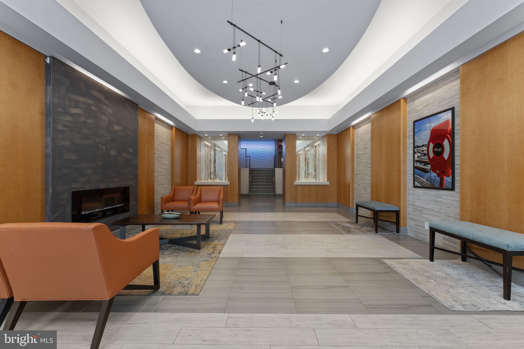 355 I Street Southwest, Unit S104 Washington, DC 20024 - Photo 24 of 64 a living room with furniture a fireplace and a chandelier