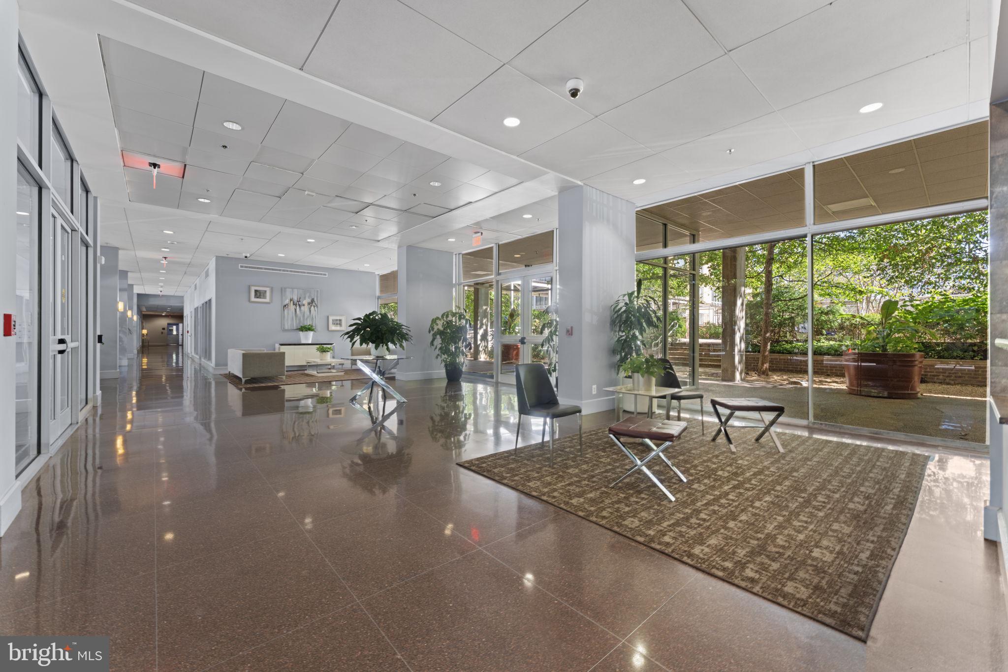 355 I Street Southwest, Unit S104 Washington, DC 20024 - Photo 26 of 64 a living room with lots of furniture and a large window