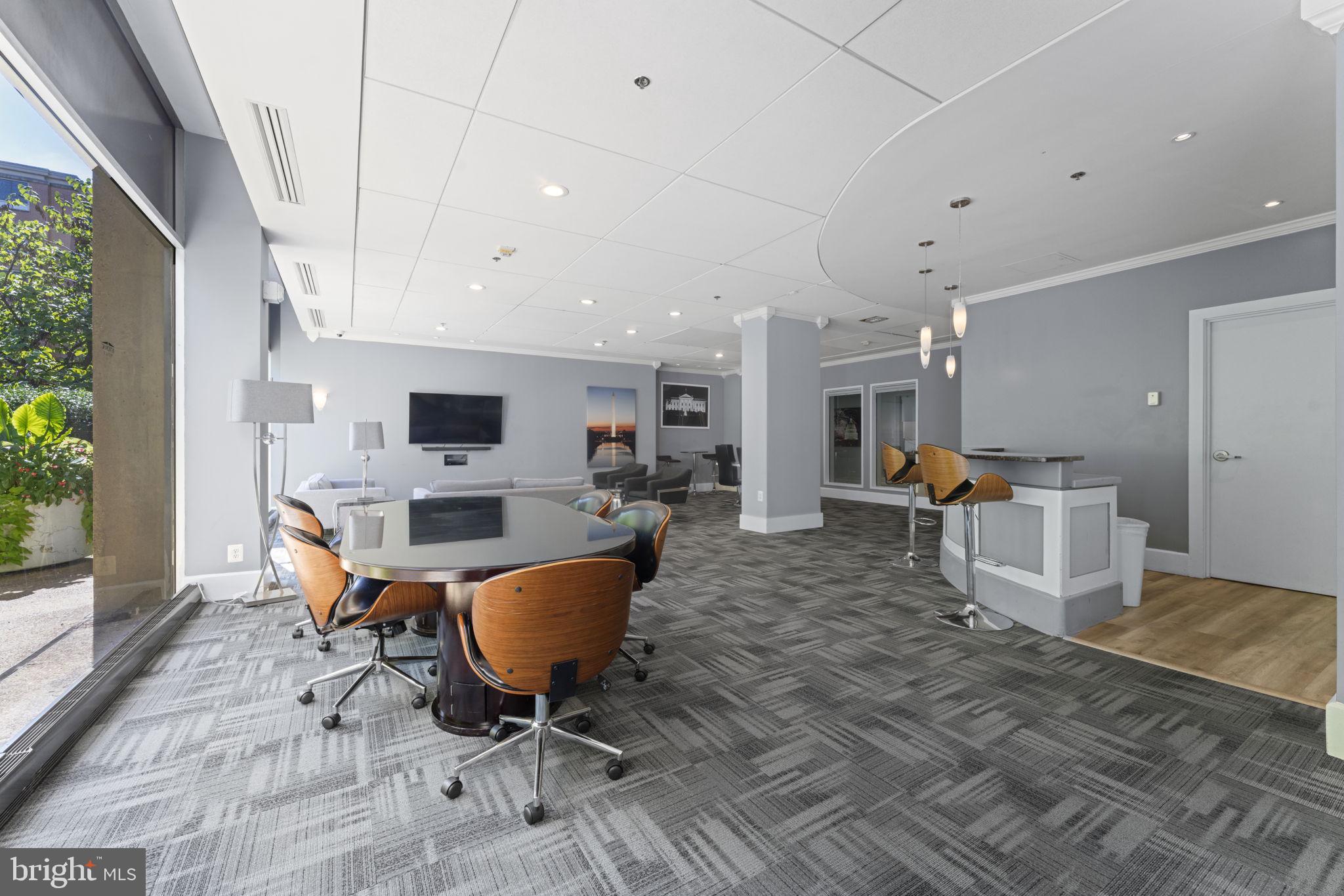 355 I Street Southwest, Unit S104 Washington, DC 20024 - Photo 32 of 64 a living room with furniture a table and chairs