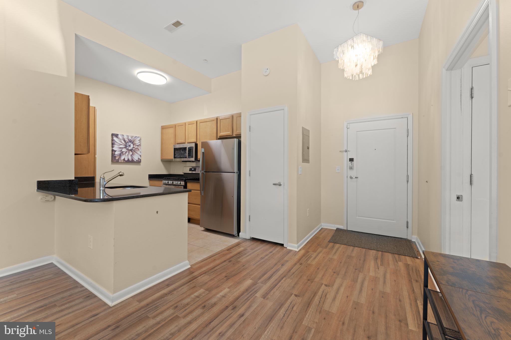 355 I Street Southwest, Unit S104 Washington, DC 20024 - Photo 4 of 64 a kitchen with a refrigerator and a stove top oven