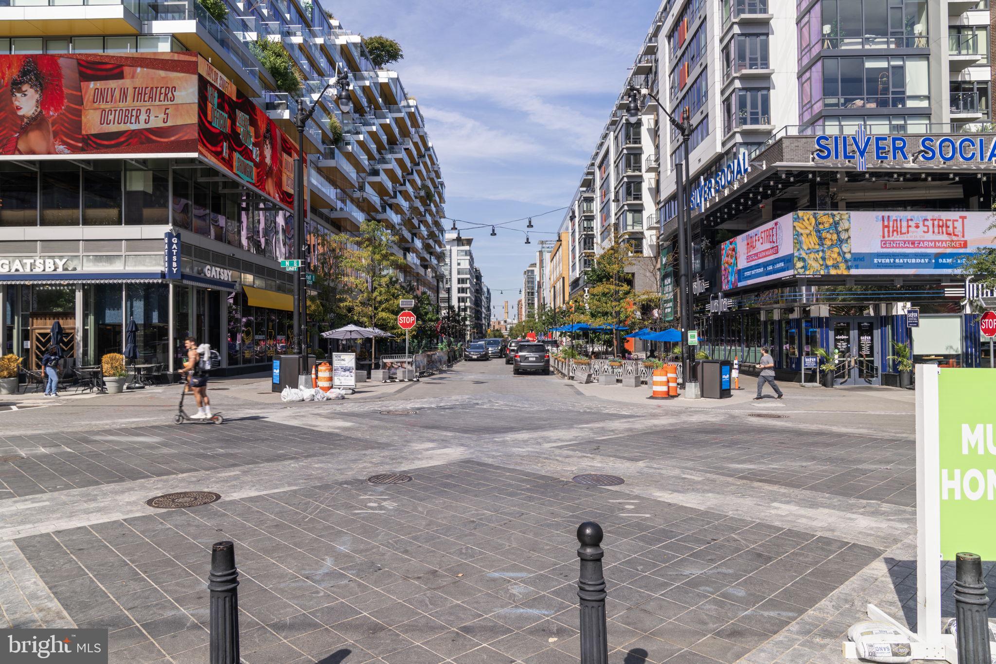 355 I Street Southwest, Unit S104 Washington, DC 20024 - Photo 41 of 64 a city street lined with tall buildings and a street light