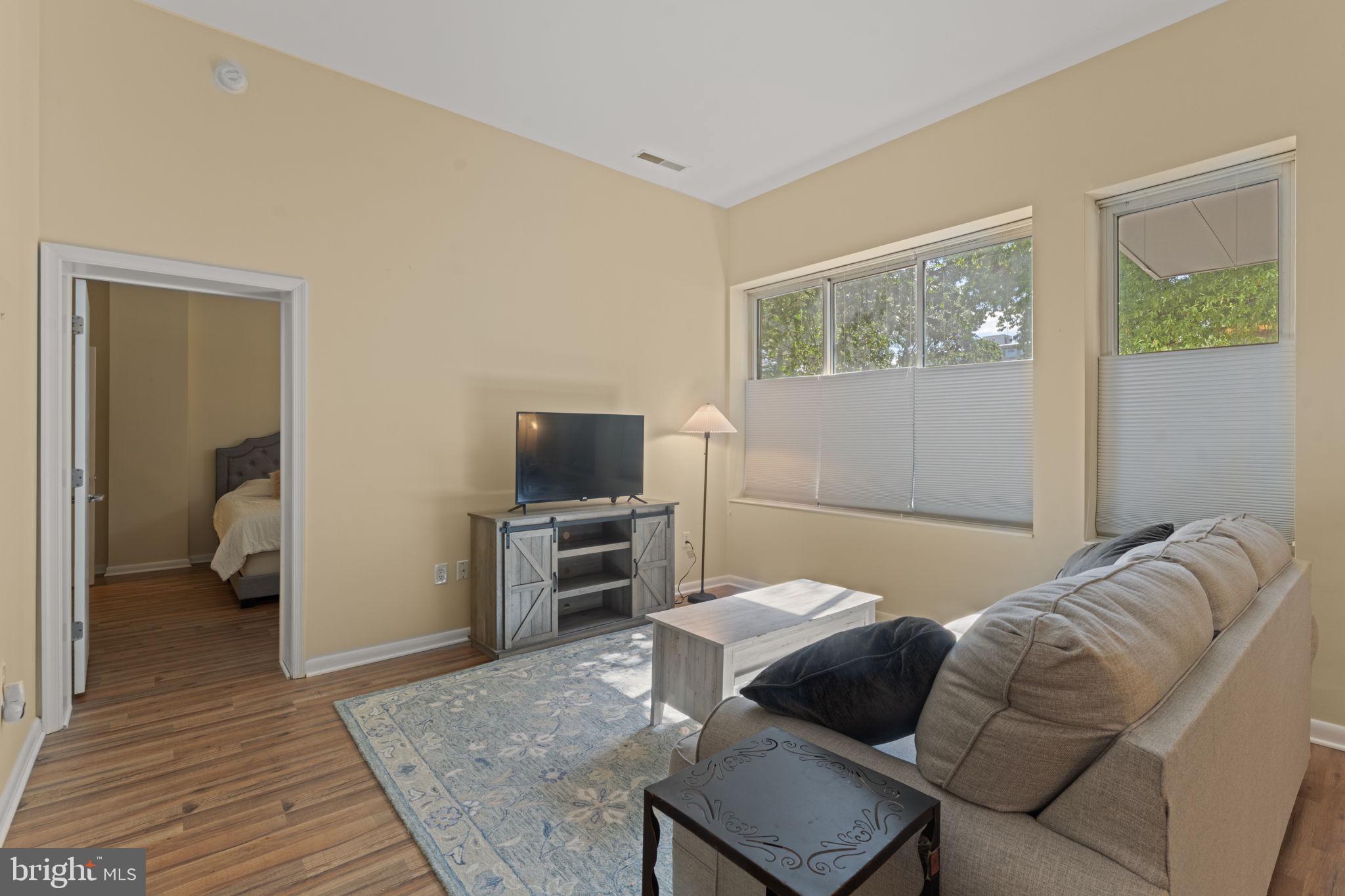 355 I Street Southwest, Unit S104 Washington, DC 20024 - Photo 9 of 64 a bedroom with a bed and wooden floor