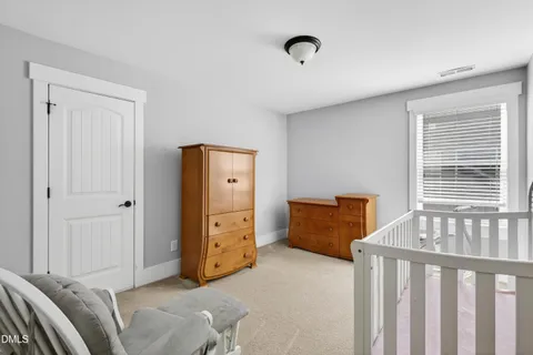 a view of an empty room with window and cabinet