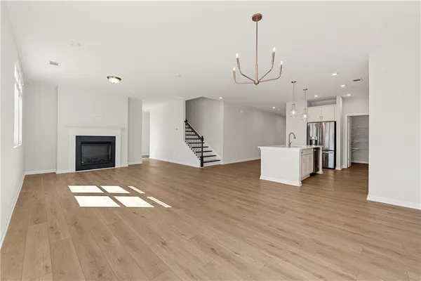 a view of a kitchen with a sink and a fireplace