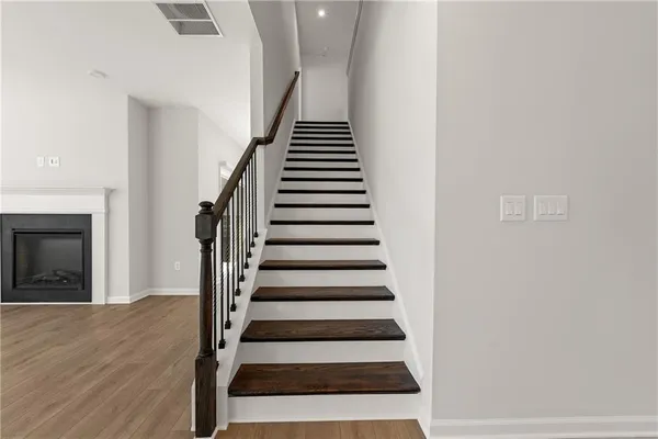 a view of entryway and hall with wooden floor