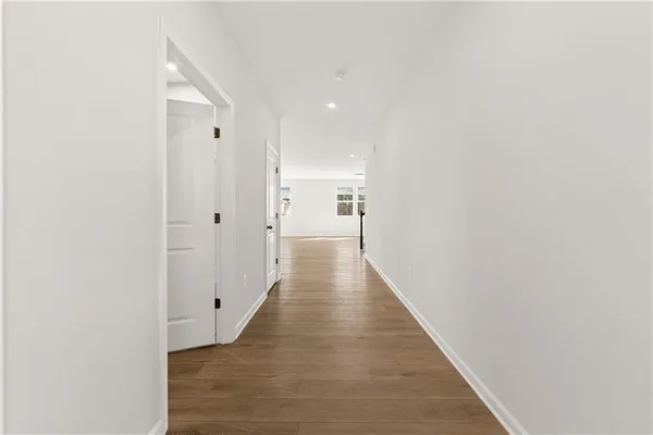 a view of a hallway with wooden floor